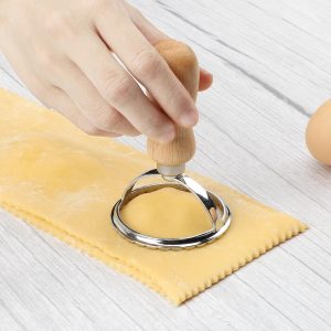 TACGEA ravioli stamp cutter set with four wooden-handled cutters featuring fluted edges and a matching fluted roller wheel for cutting and sealing pasta.