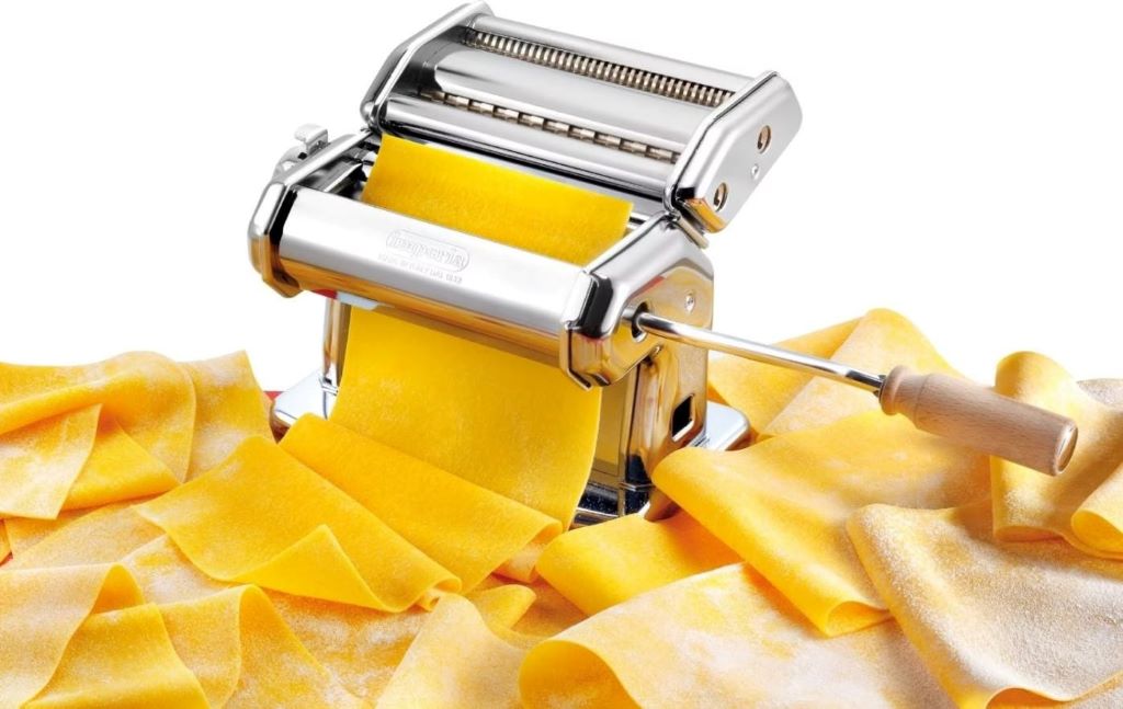 Home cook making fresh pasta with a high-quality pasta machine.