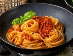 A variety of pasta dishes from different cultures on a dining table.
