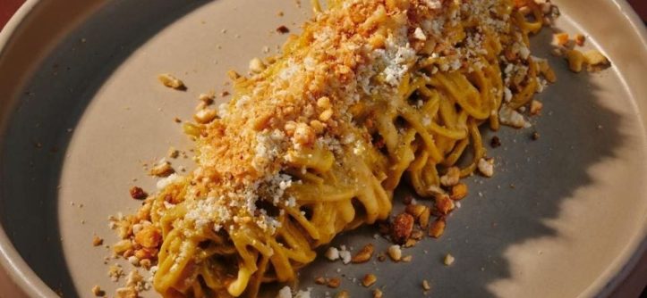 A colorful collage of popular international pasta dishes, including Italian spaghetti, Japanese ramen, and Thai pad see ew, symbolizing the global rise of pasta trends.