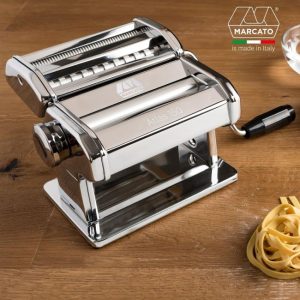 Homemade fettuccine being rolled through the MARCATO Atlas 150 manual pasta machine