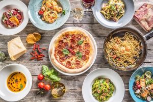 Assortment of pasta dishes from around the world served on a large table.