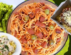 Ten unique pasta dishes from Asia and South America displayed on a table.