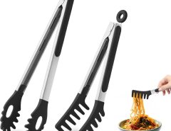 Stainless steel pasta fork lifting cooked spaghetti from pot in modern kitchen.