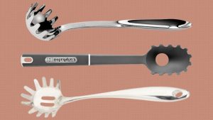 Durable pasta fork holding long pasta strands for easy cooking and serving.