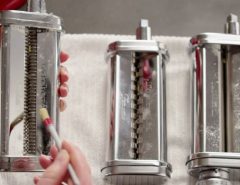 Cleaning a Marcato pasta machine after use in a kitchen for proper maintenance