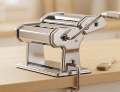 Applying food-grade oil to the gears of a pasta maker