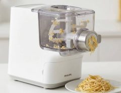 Cleaning the rollers of a fully automatic electric pasta maker with a soft brush