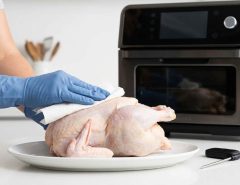 Juicy whole chicken cooked in a smart air fryer oven with golden skin