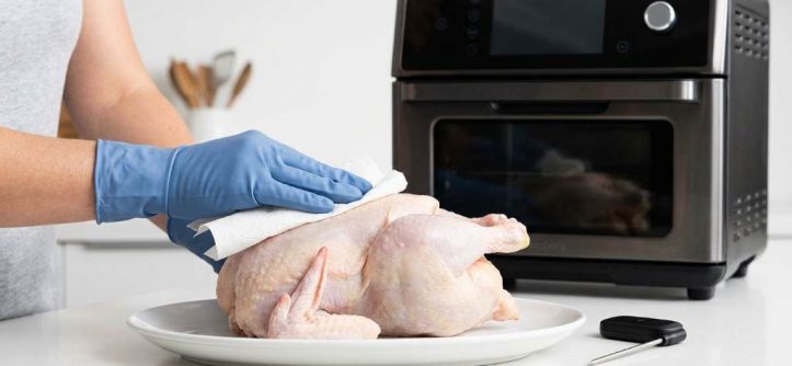 Juicy whole chicken cooked in a smart air fryer oven with golden skin