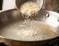 Smooth melted cheese sauce poured over cooked pasta